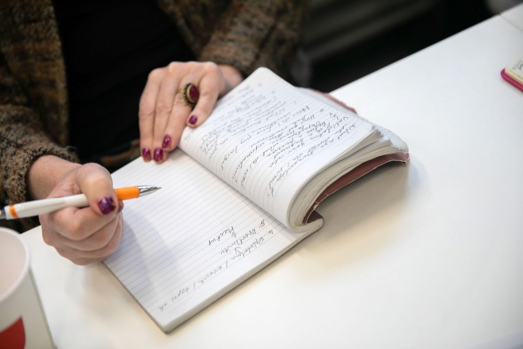 Lady writing in notepad