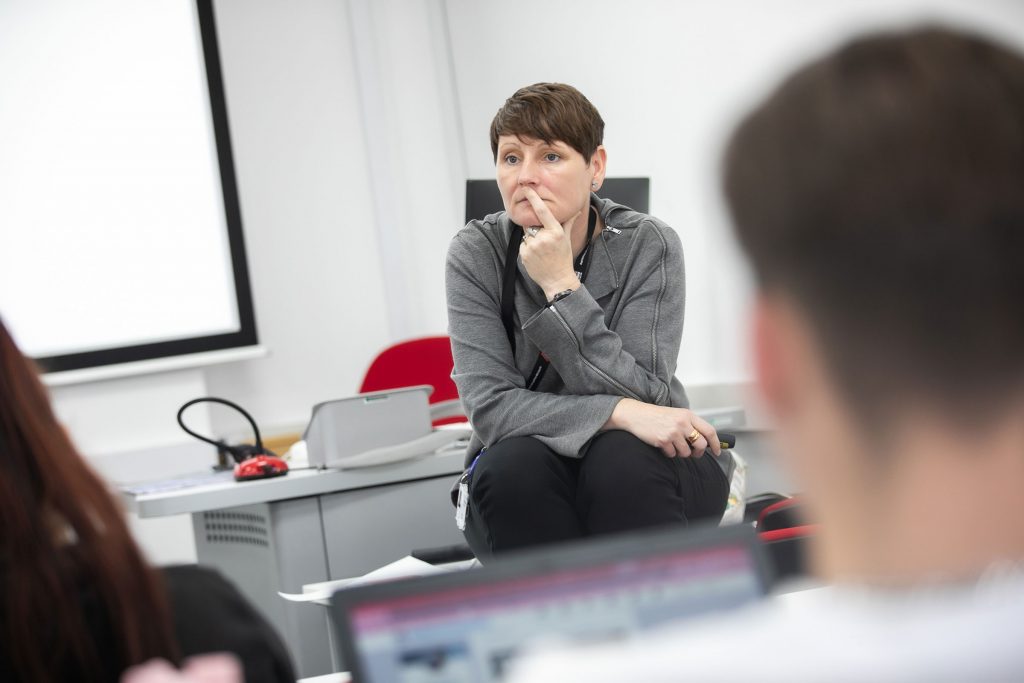 Lecturer listening to class