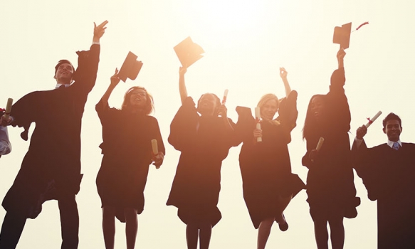 Graduation students throwing their caps in the air