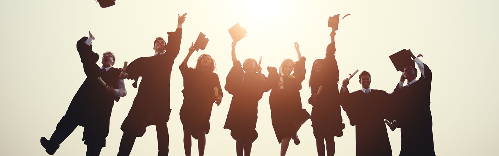 Graduation students throwing their caps in the air