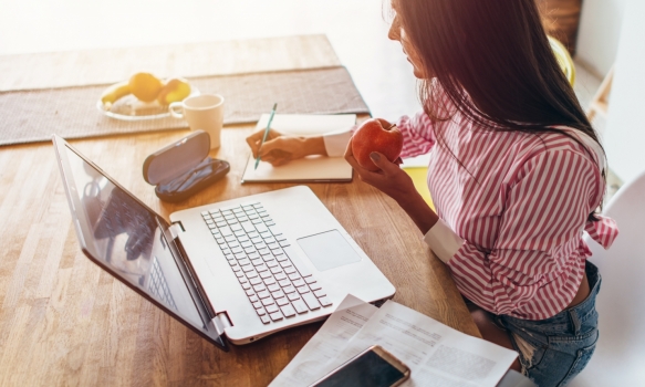 Woman taking notes on her finances