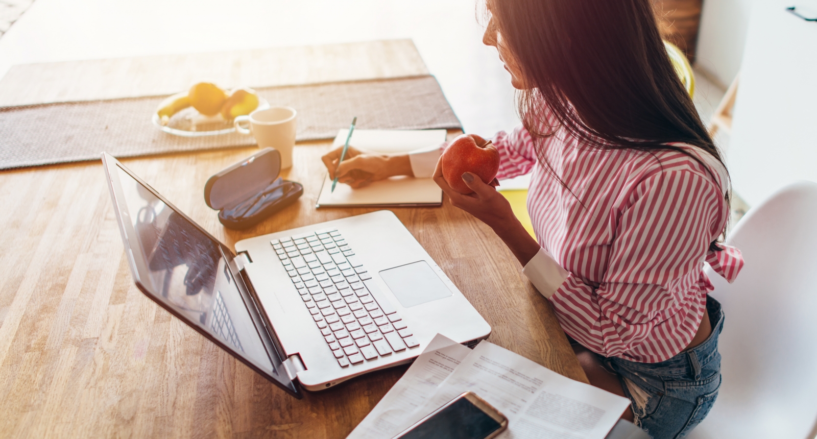 Woman taking notes on her finances