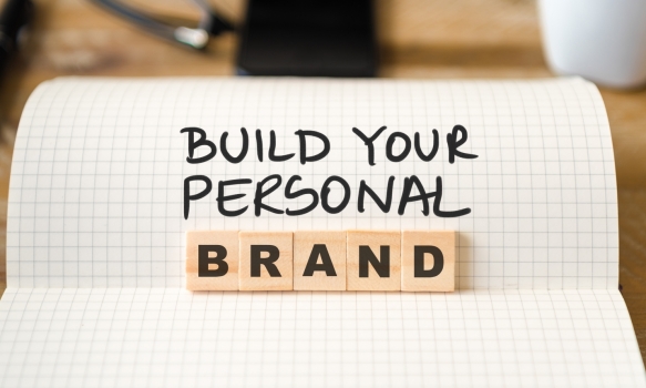 Ruled book and blocks saying building your personal brand