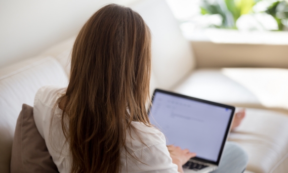 A woman writing her covering letter on her laptop