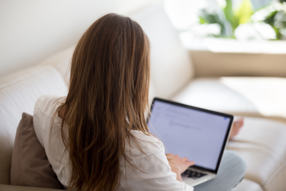 A woman writing her covering letter on her laptop