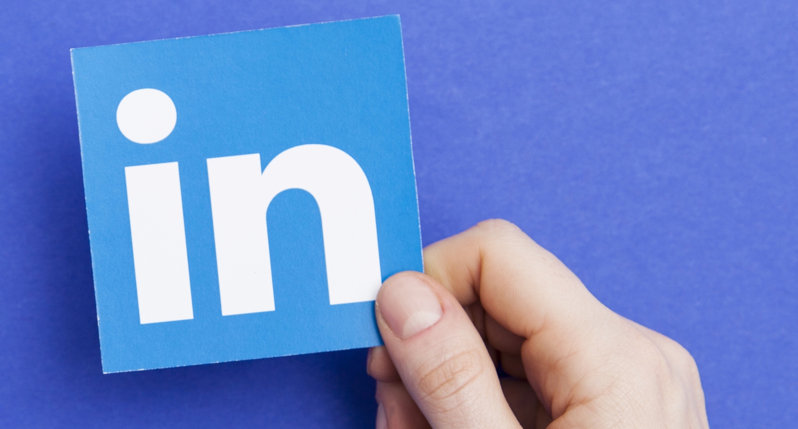 Hand holding the LinkedIn icon