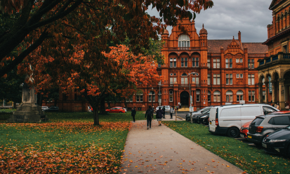 An inspiring photo of the Red brick Peel building and greenery infront