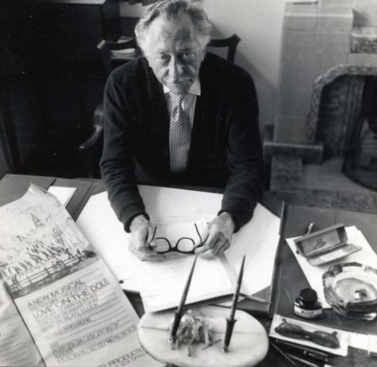 Walter Greenwood sitting at his desk