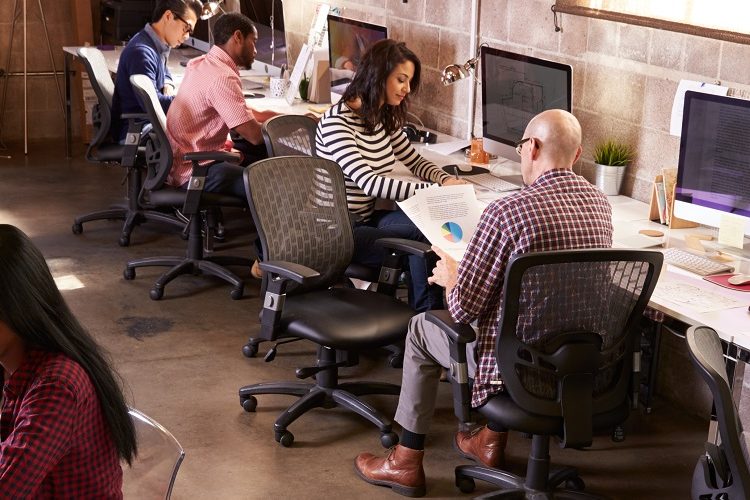 Image: a group of people working in an office