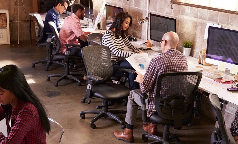 Image: a group of people working in an office