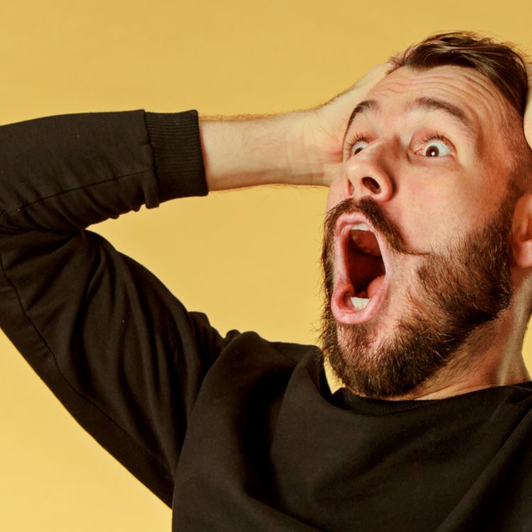 image: man holding head with hands shocked and excited