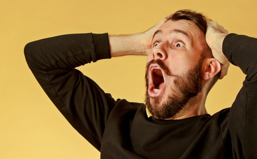 image: man holding head with hands shocked and excited