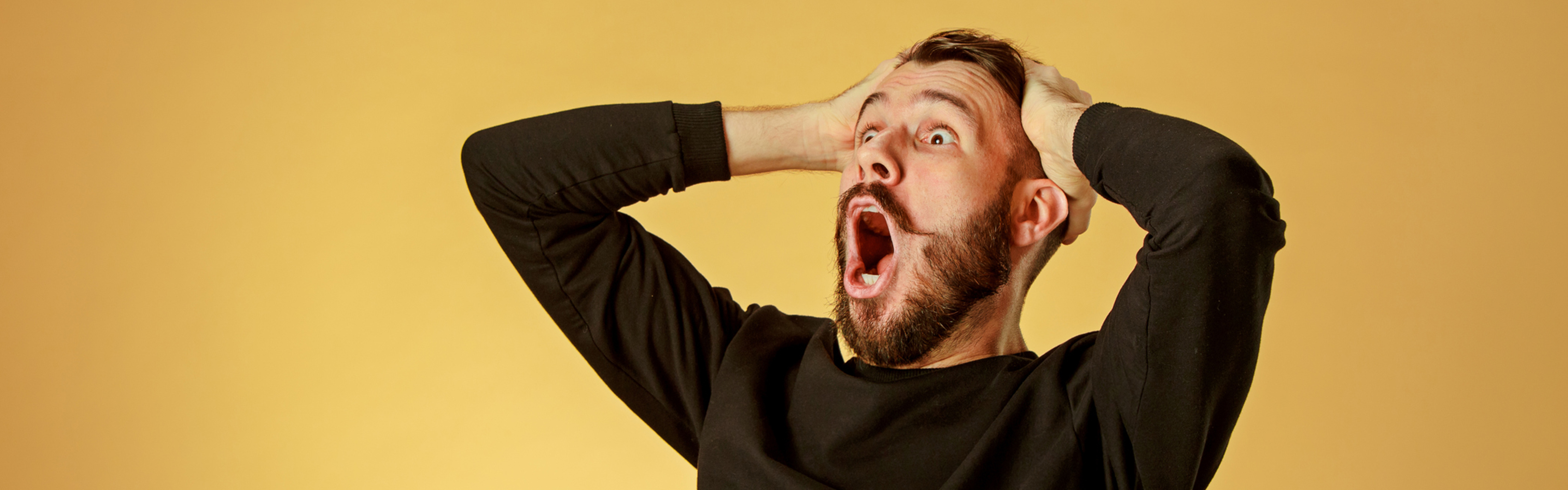 image: man holding head with hands shocked and excited