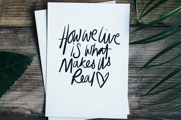 Image: Card with "How we live is what makes us real" text