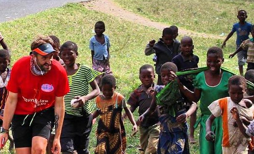 Image: Brendan running accompanied by children