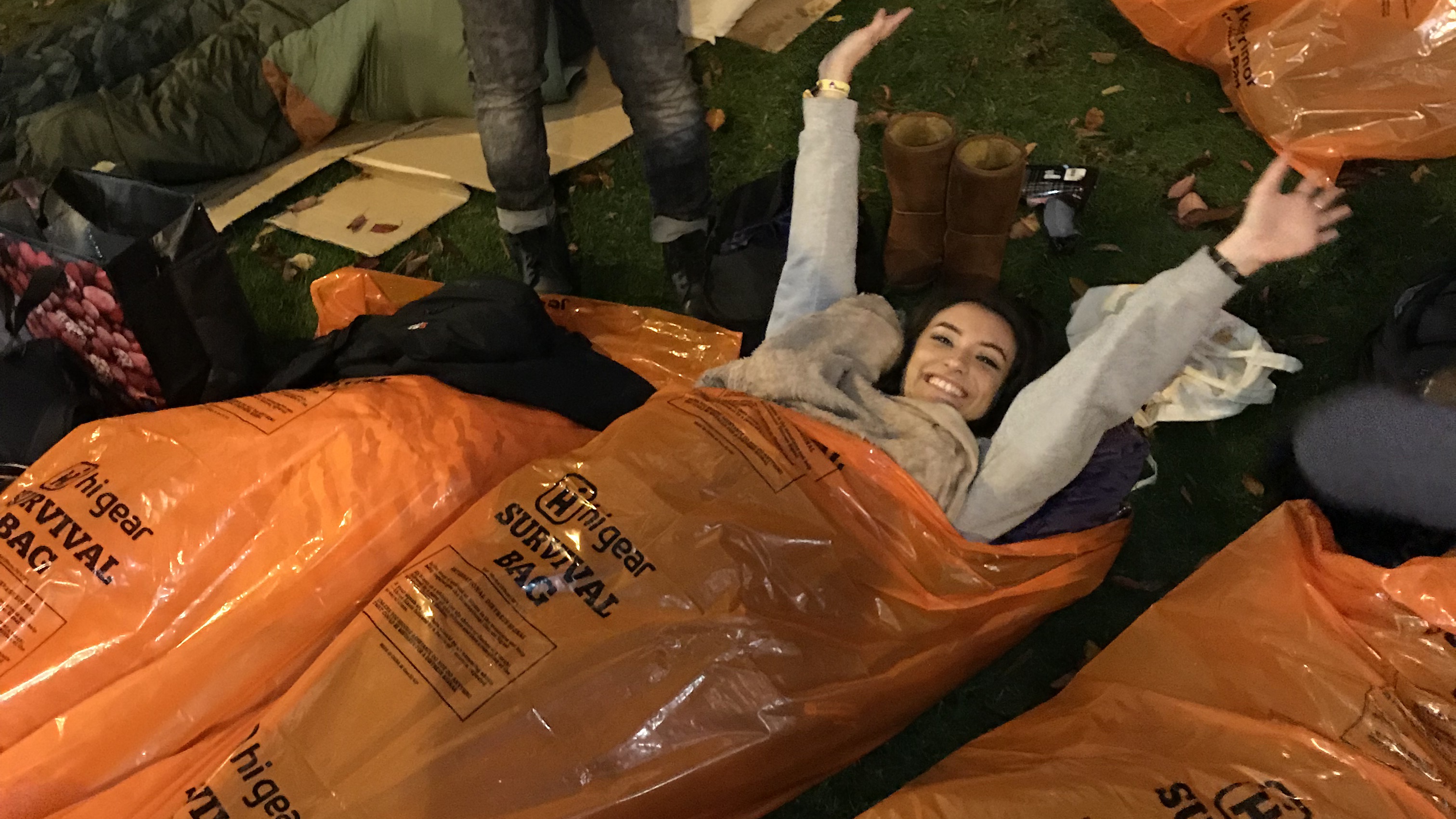 Image: Woman sleeping out with hands in the air