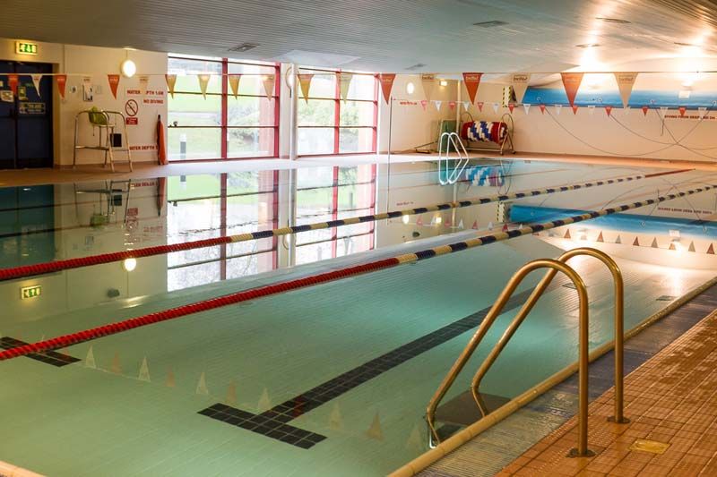 This shows the swimming pool located inside the University of Salford's sports centre. You can see the pool ladders and equipment surrounding it. 