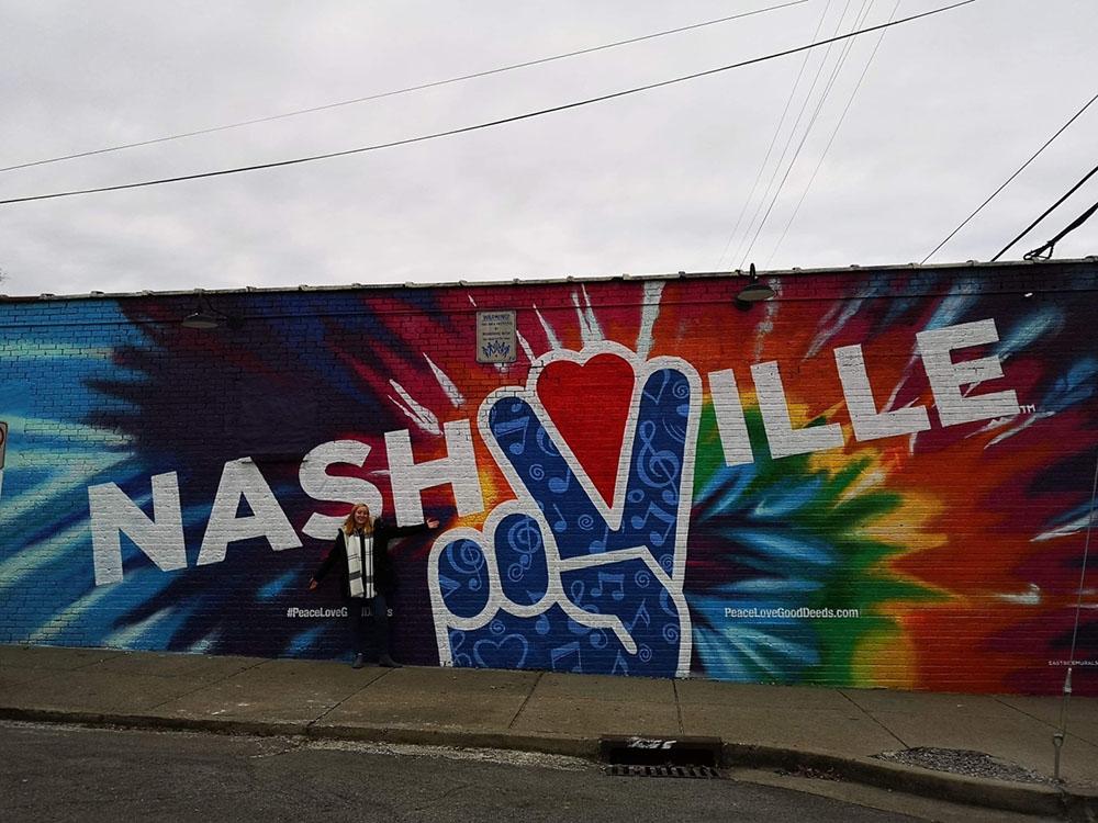 Incredible street art/mural in Music City, Nashville with a peace sign on and a rainbow effect in the background.