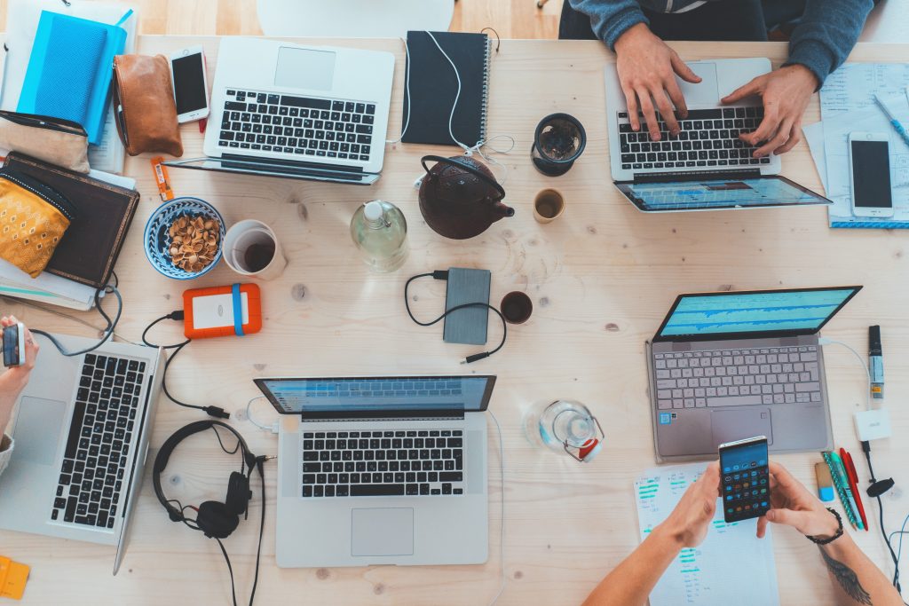 a birds eye view of numerous laptops on a table