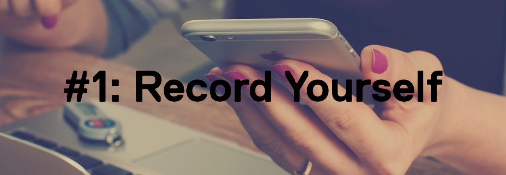 Photo by William Iven on Unsplash. The background shows a faded image of a woman with pink nails on her iphone. The foreground has the text '#1: Record Yourself'.