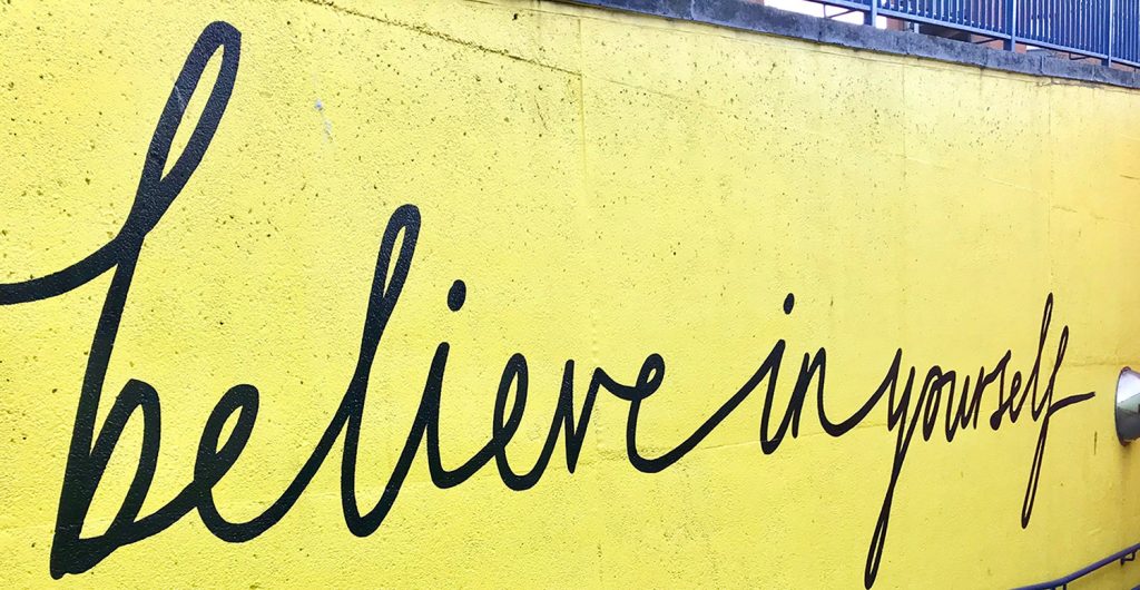 street art that reads 'Believe in yourself' in cursive