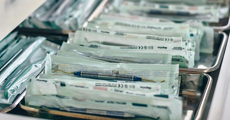 A close up focus shot of white packs from a medical lab in steel dishes.