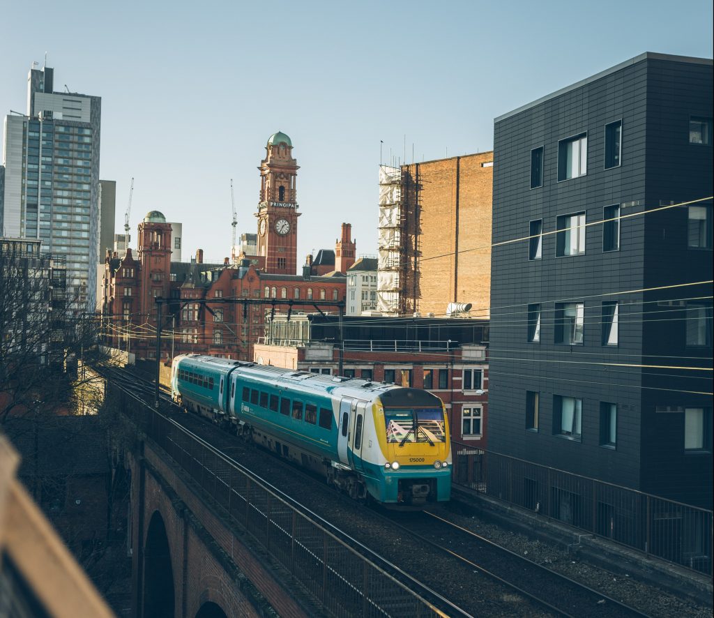 Train passing by the Manchester skyline