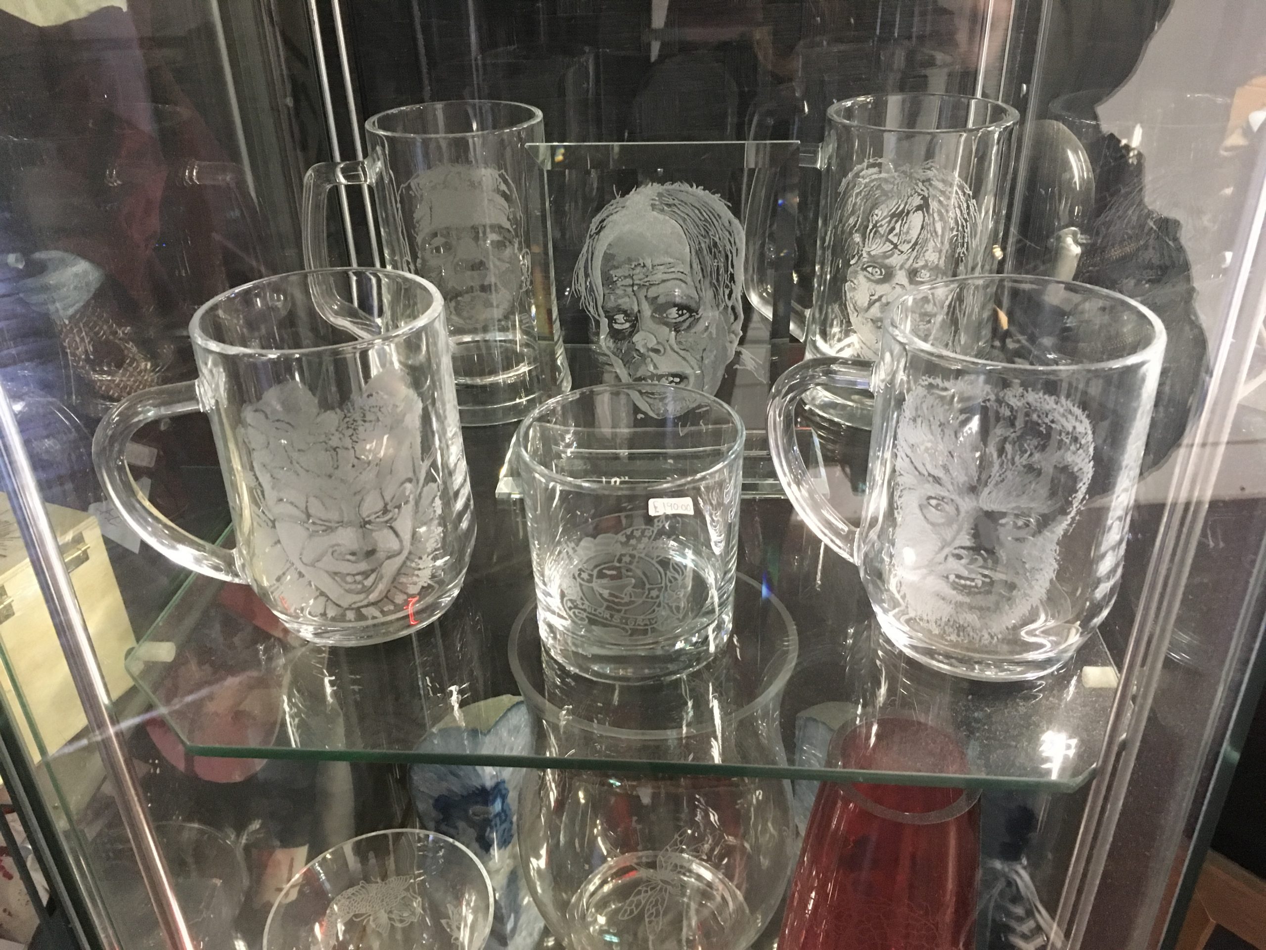 Engraved glasses with a variety of horror faces on them