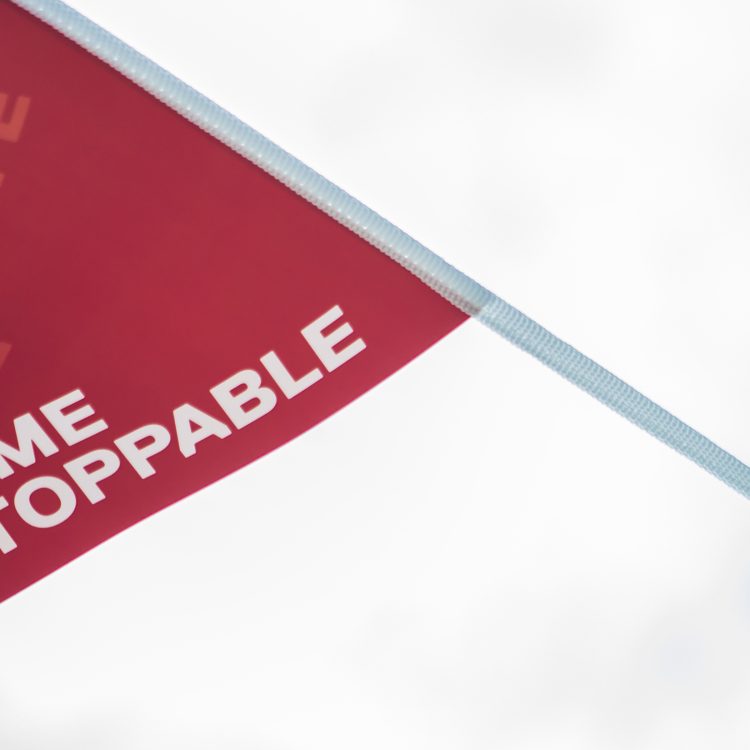 Become Unstoppable written on a red flag blowing in the wind