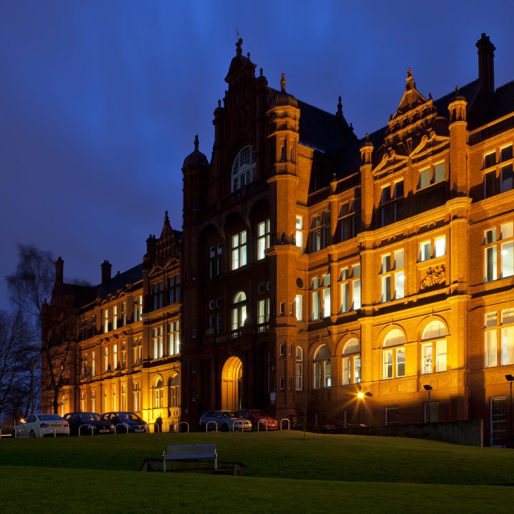 Photo of the Peel Building at night with lights on