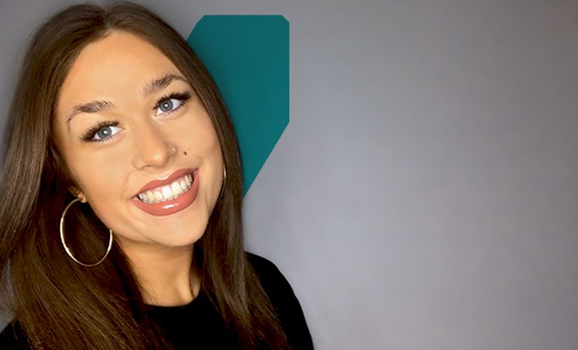 Megan smiling in front of a white background