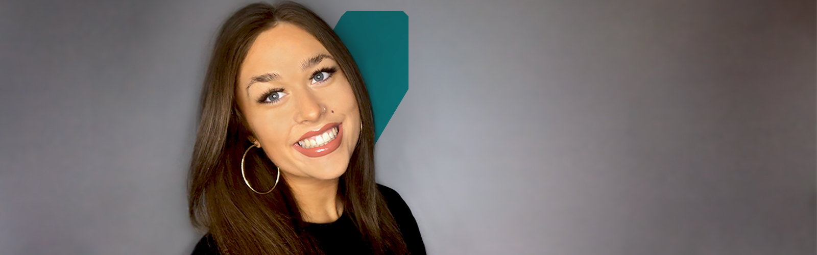 Megan smiling in front of a white background