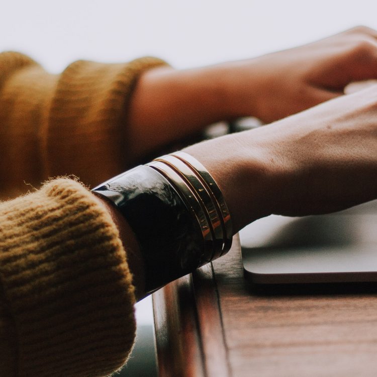 Photo of person's hand typing in her laptop