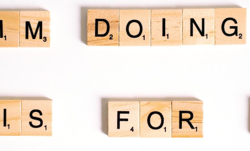 Photo of alphabet blocks arranged to make a sentence saying "IM DOING THIS FOR ME"