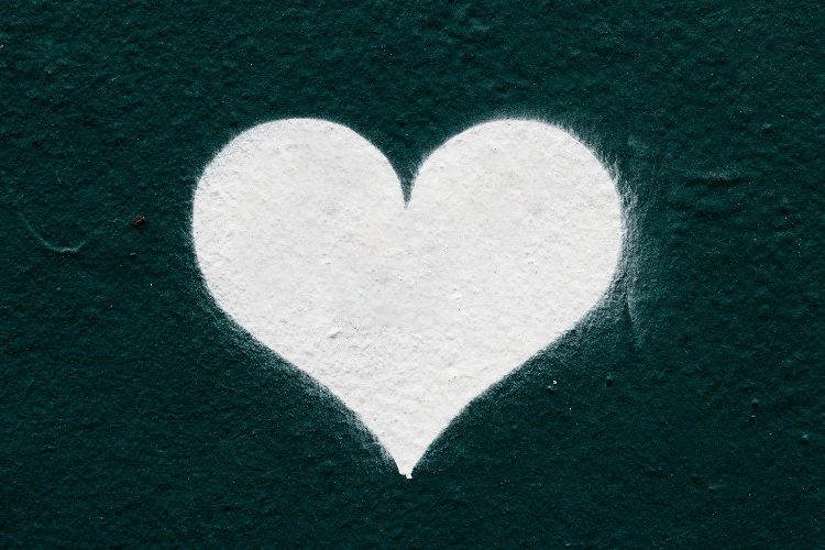 Image of white chalk heart on a dark background