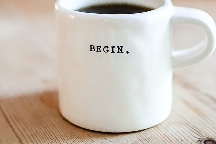 Image of a coffee mug with the word "begin" printed on it