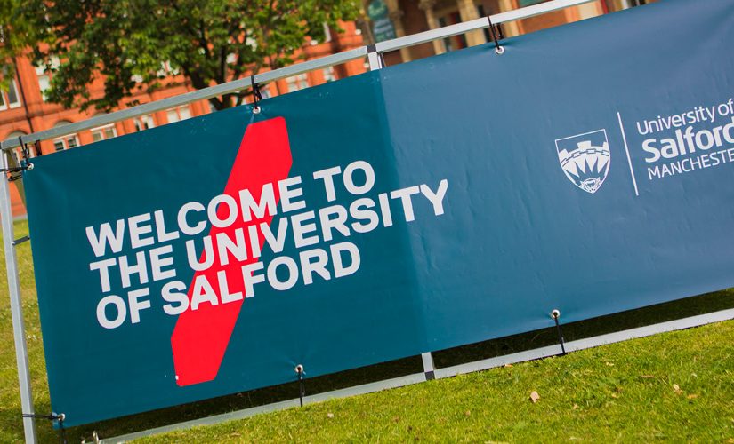 Photo of Uni of Salford Welcome Banner infront of Maxwell Building