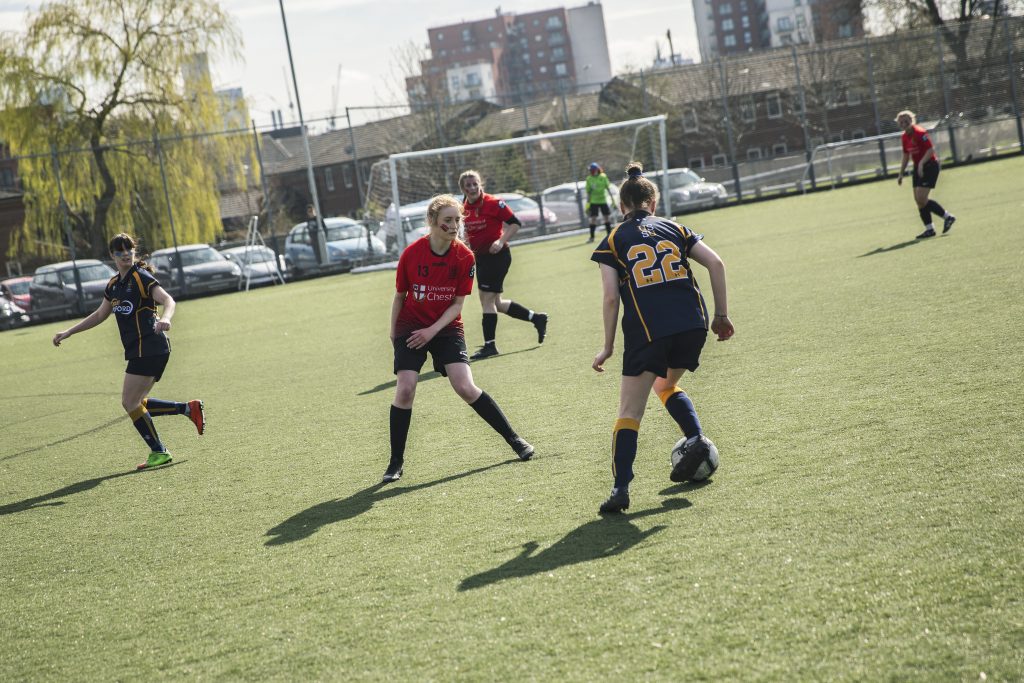 Two teams playing football on AstroTurf 