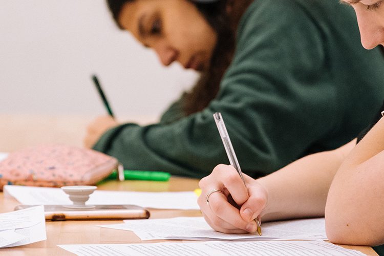 Two students writing in exam