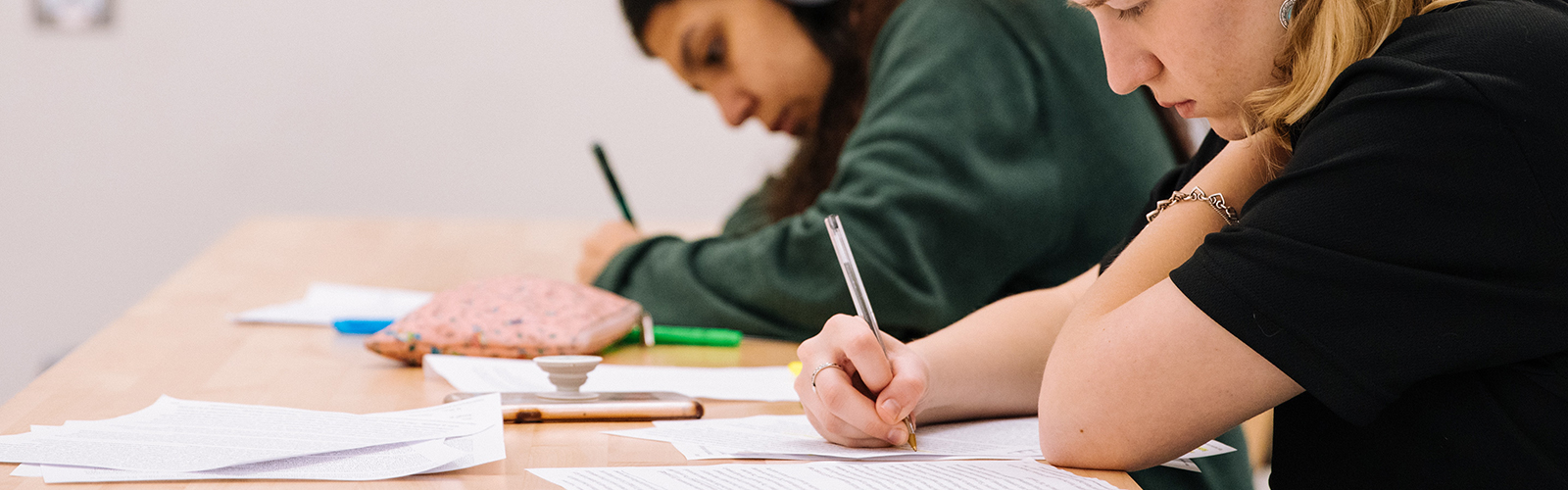 Two students writing in exam