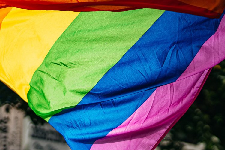 People holding the LGBTQ Flag