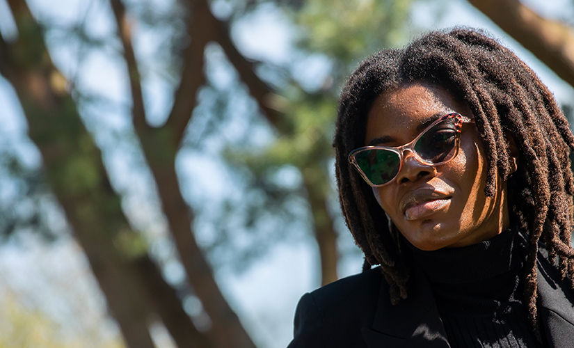 Photo of a women with glasses talking to a man on the other side