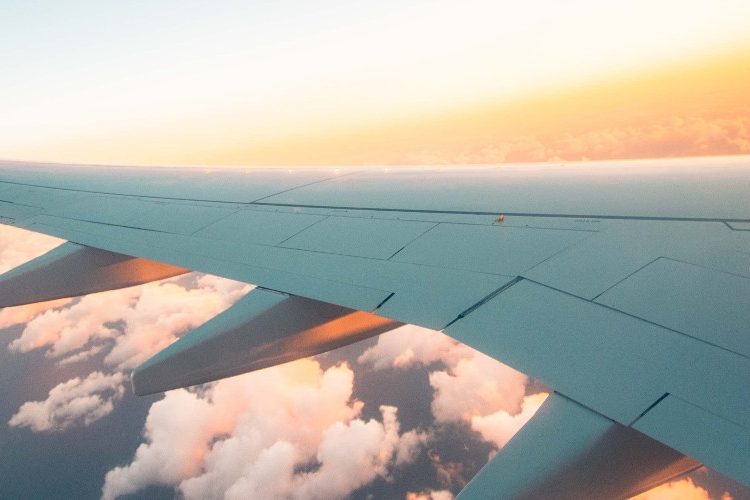 Photo of a plane's wing out of the window of a plane