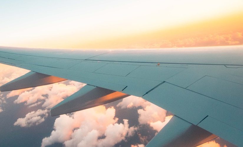 Photo of a plane's wing out of the window of a plane