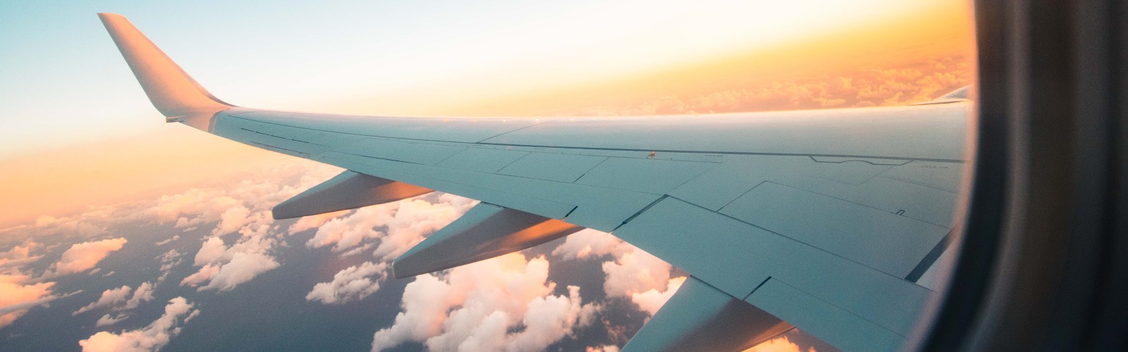 Photo of a plane's wing out of the window of a plane