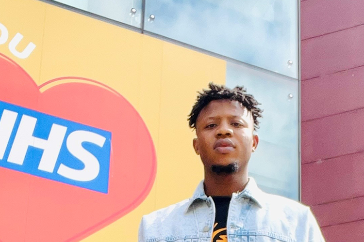 Cropped Photo of a man standing infront of the Mary Seacole Building