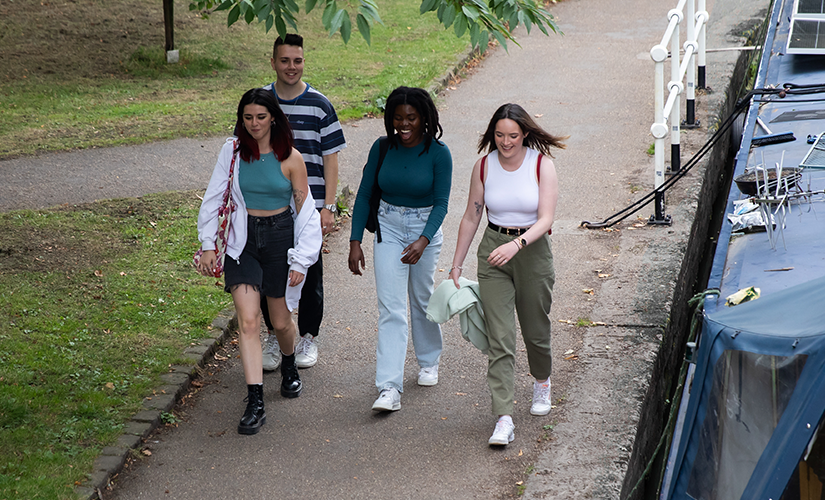 Photo of friends walking alongside water trail