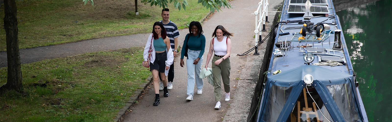 Photo of friends walking alongside water trail