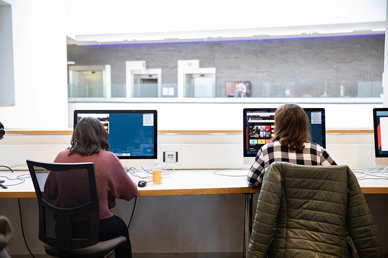 Two students browsing the Student Hub for the latest updates.