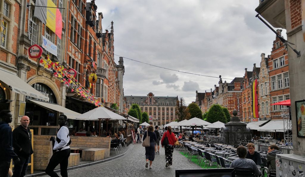 Oude Market square: outside seating surrounded by beautiful buildings with people walking around